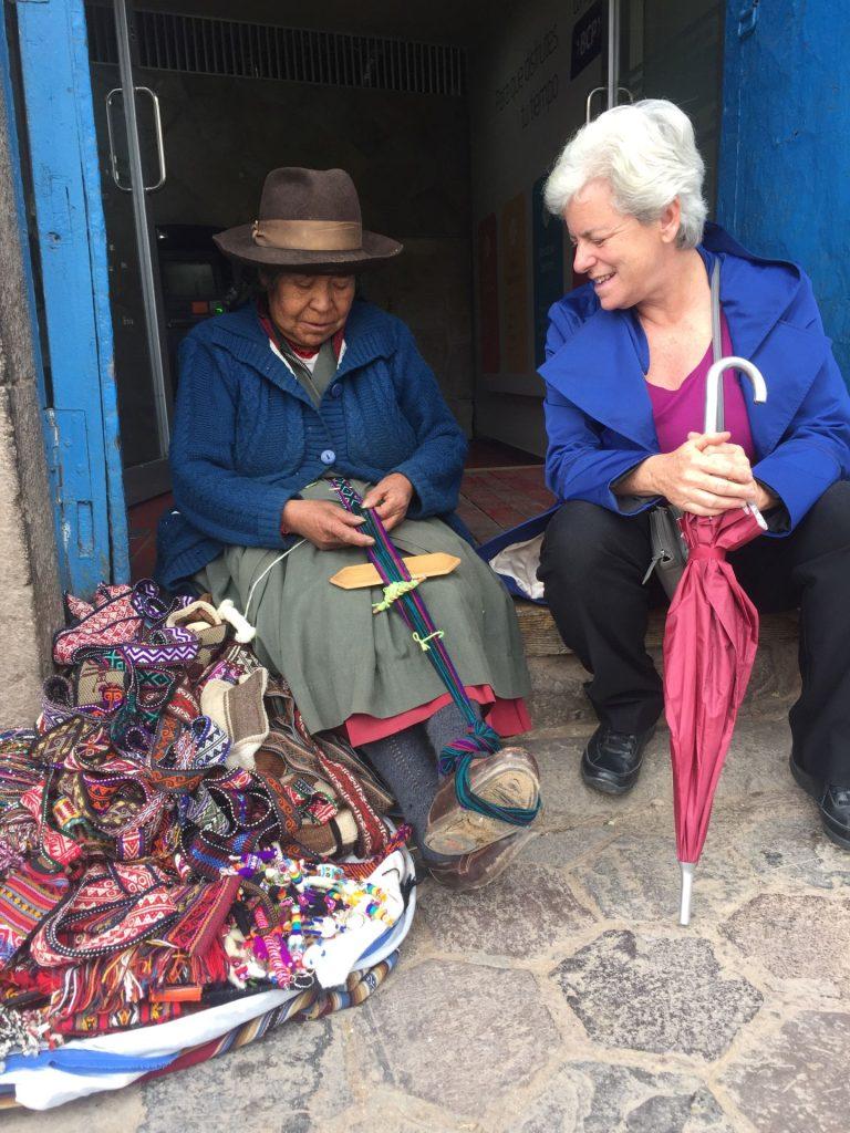 Old lady in Cusco teaches Tema how to weave