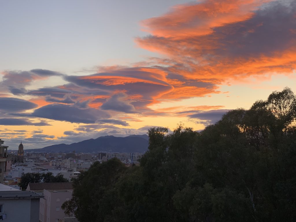 Sun setting over Malaga, Spain
