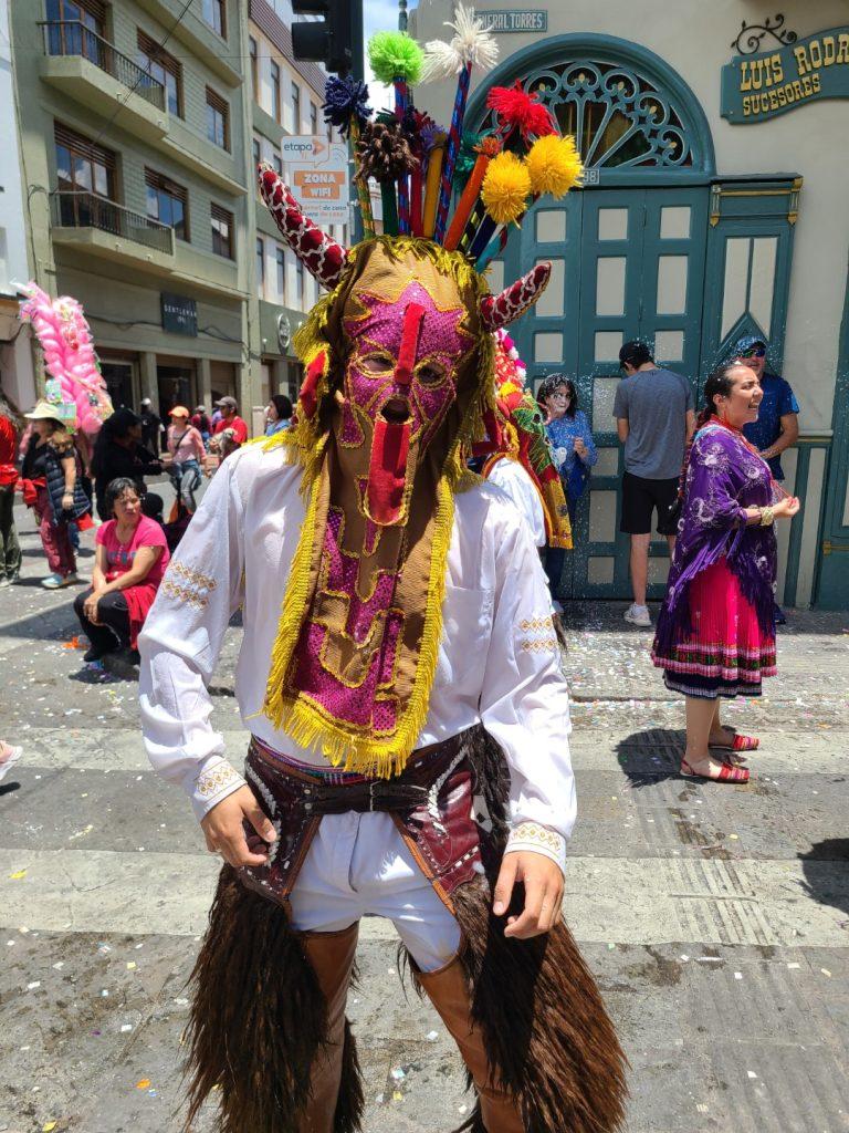 Street dancer in traditional outfit during Carnaval in Cuenca, Ecuador