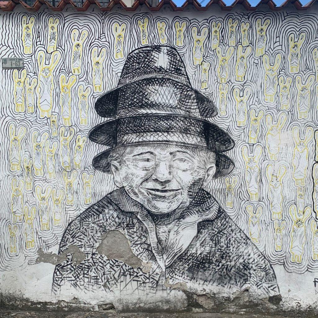 Man of many hats - street art in Cuenca Ecuador