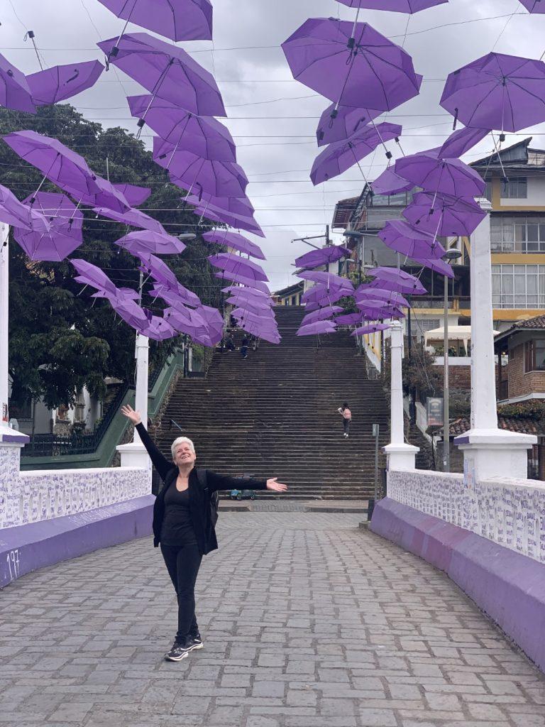 Happy Tema on a sad bridge: the purple umbrellas commemorate deaths by femicide. Names of the murdered are written on the walls