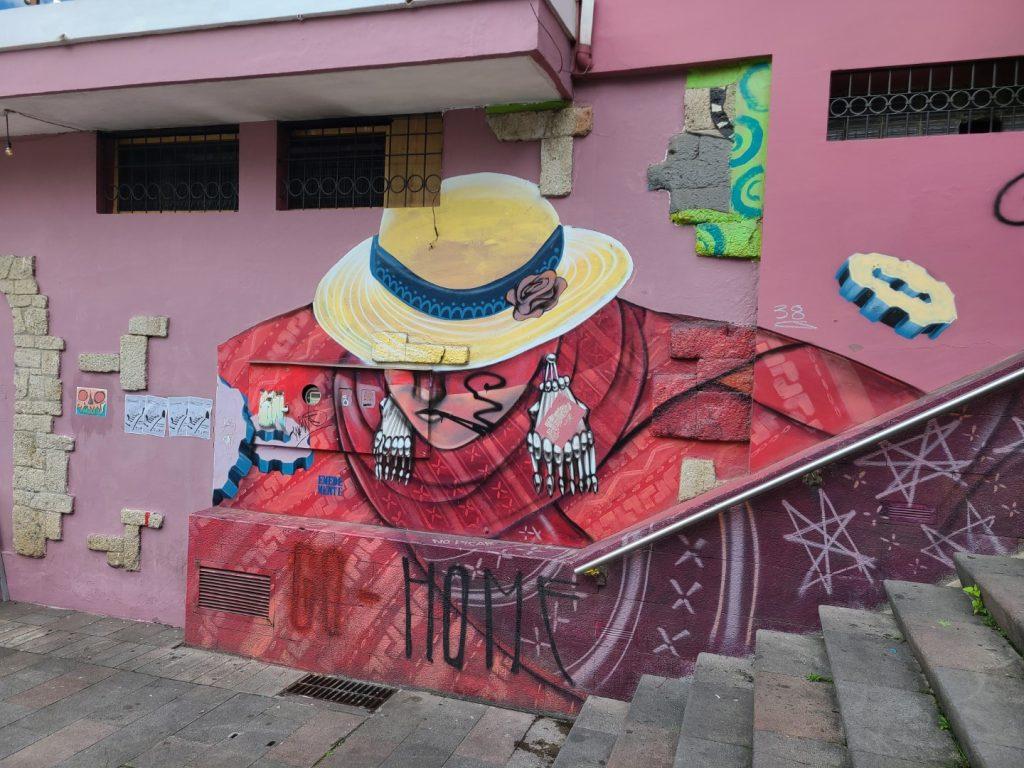 Mural of a woman in a hat, along one of the many staircases up from the river to the historic centre in Cuenca