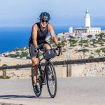 John Shaw cycling on Mallorca near Cap de Formentor lighthouse