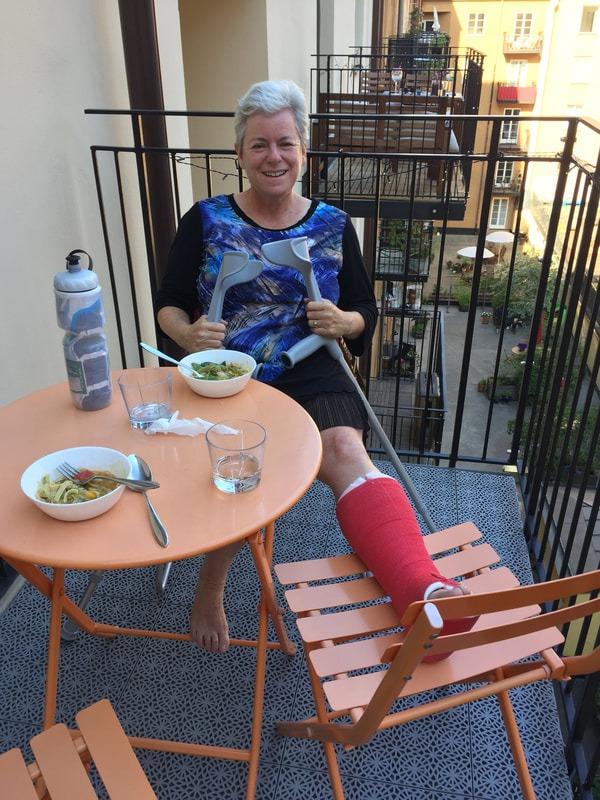 Tema Frank, with leg in a cast, on her balcony in Stockholm